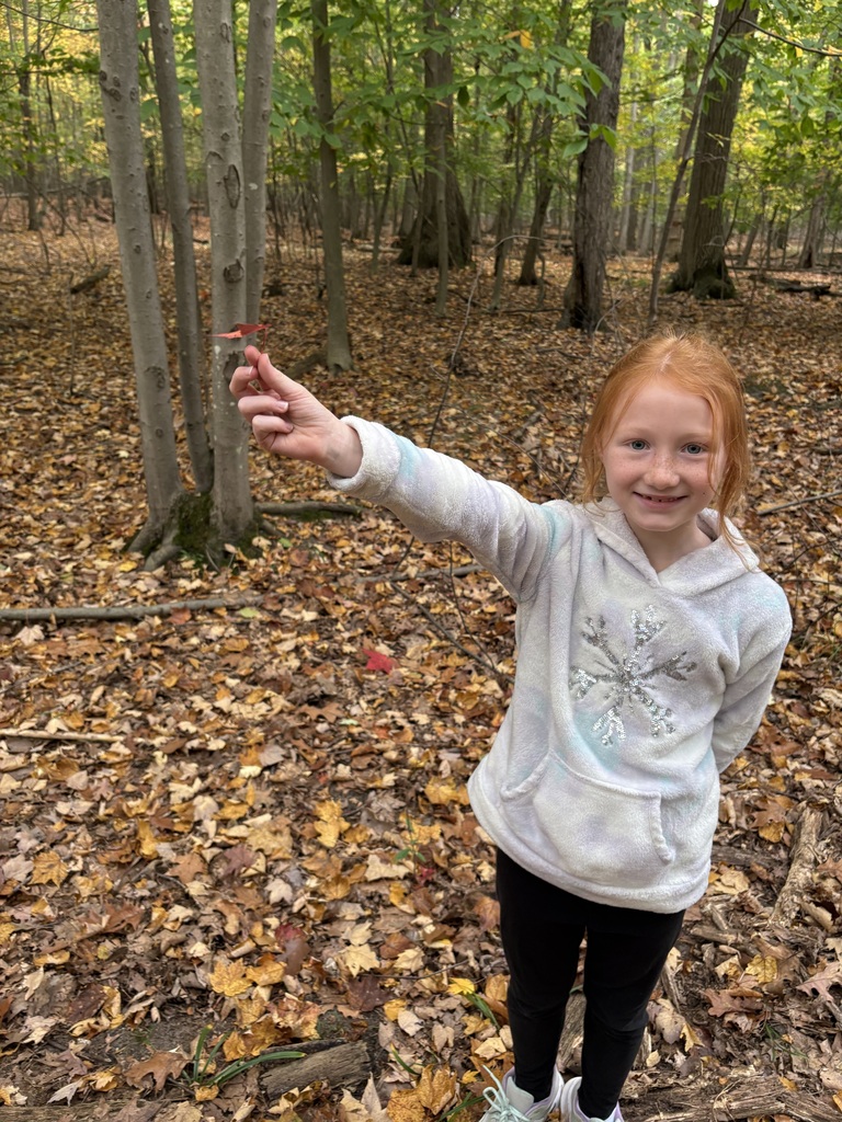 student holding a leaf