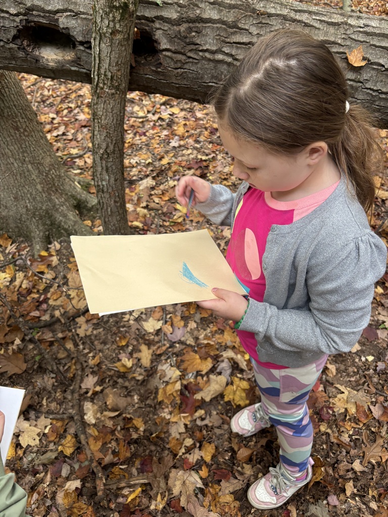 student doing a leaf rubbing
