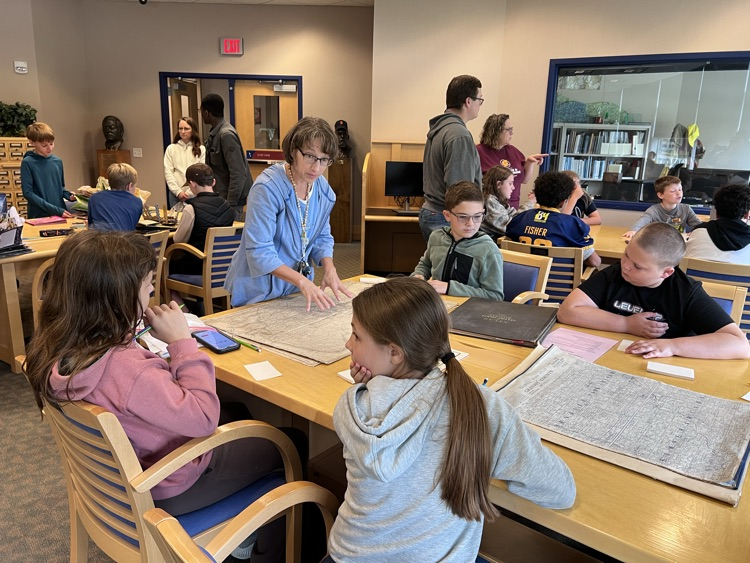 students looking at artifacts at CMU’s library