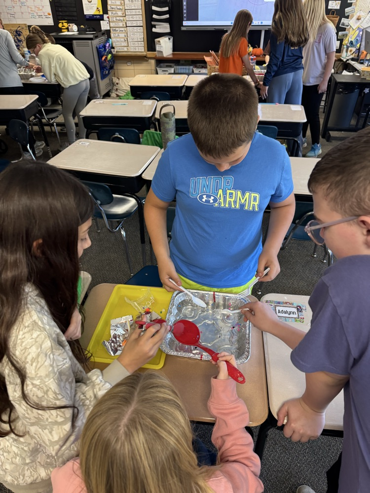 students working on removing trash from the water
