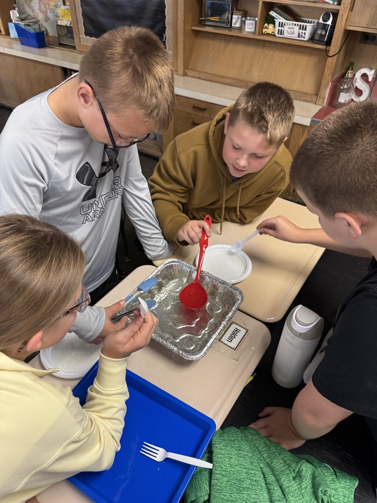 students working on removing oil from the water