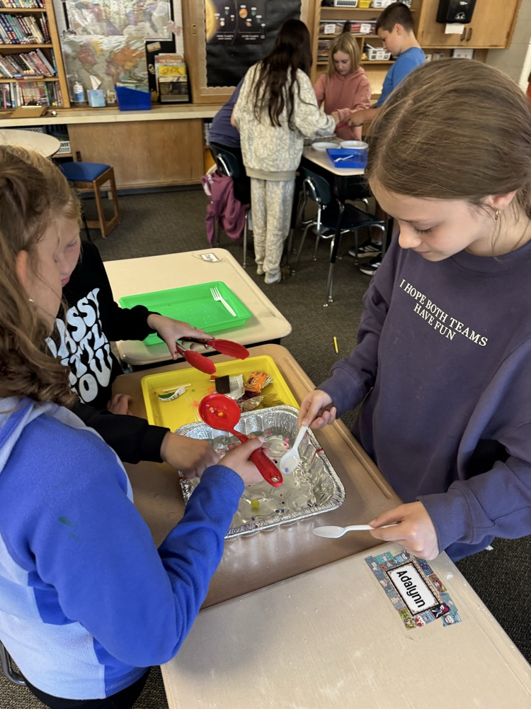 students working on removing trash from the water