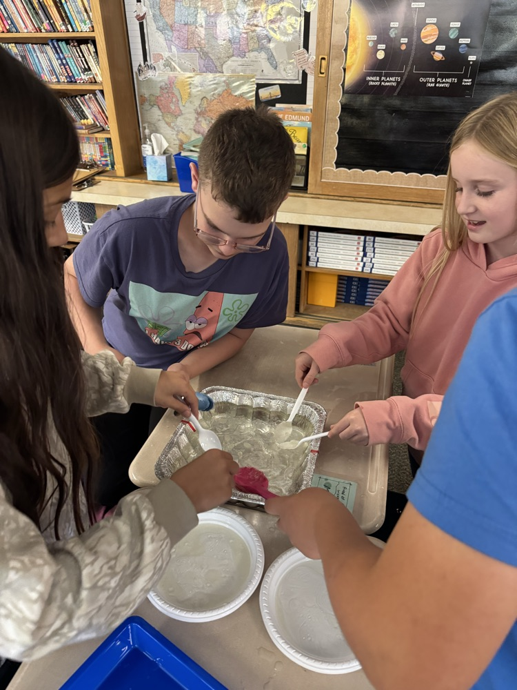 students working on removing oil from the water