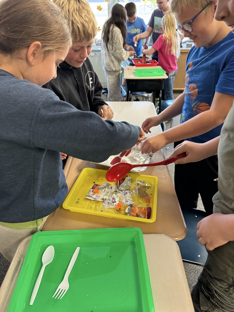 students working on removing trash from the water