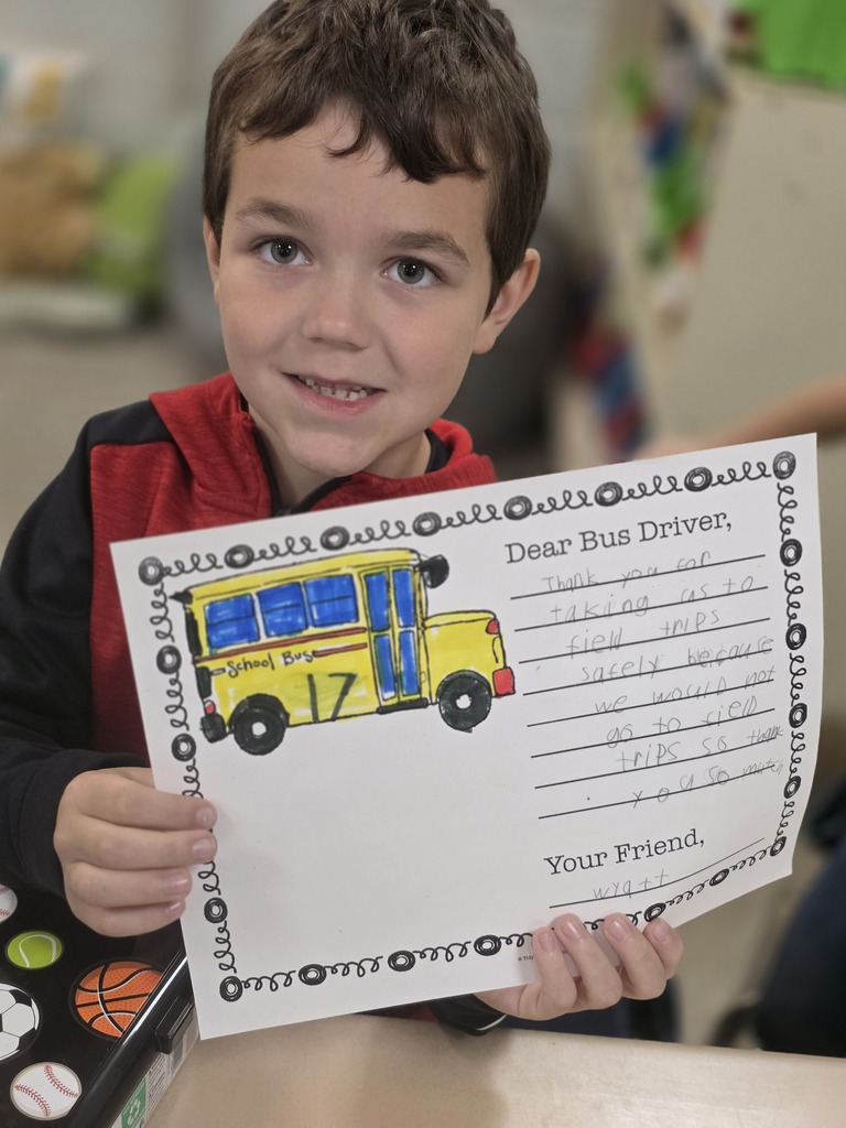 Student holding a letter to a bus driver.