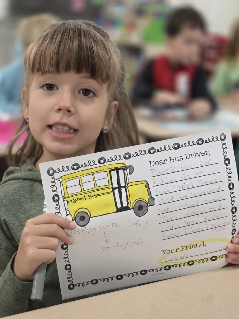 Student holding a letter to a bus driver.