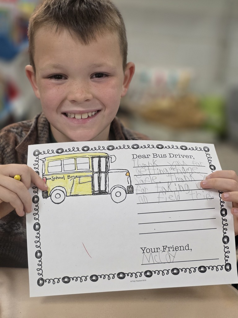 Student holding a letter to a bus driver.