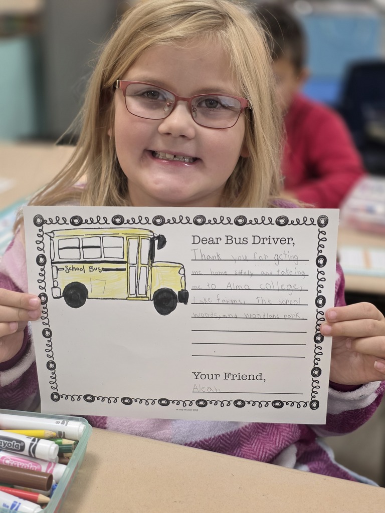 Student holding a letter to a bus driver.