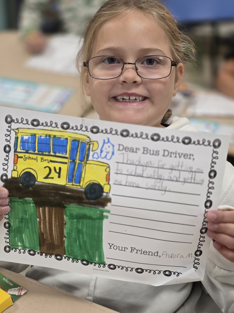 Student holding a letter to a bus driver.