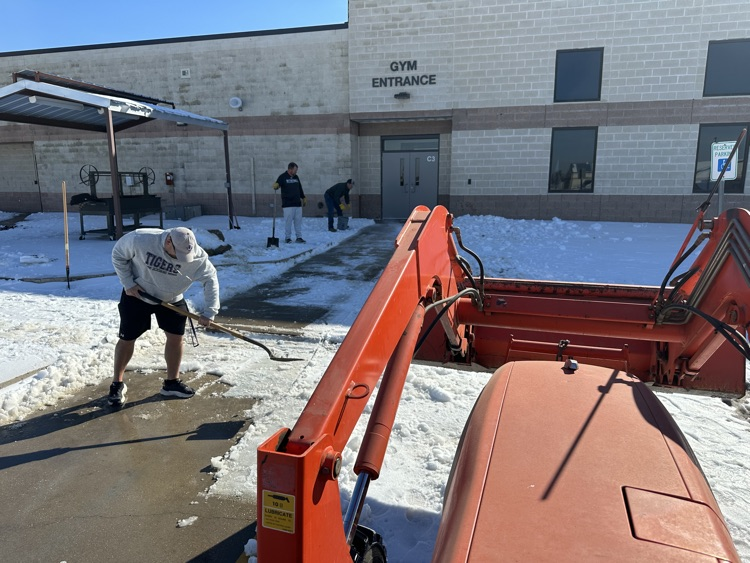 Coaches helping to clear sidewalks
