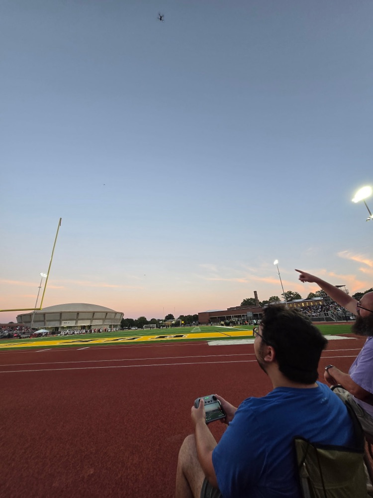 student flying drone