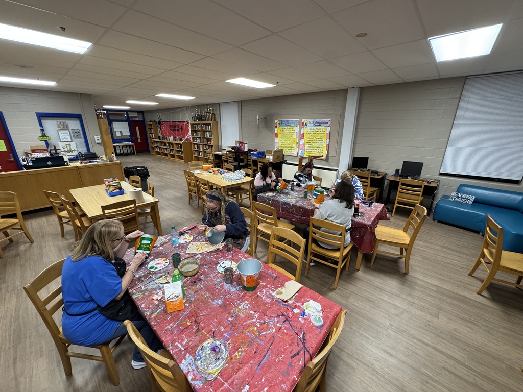 Families painting in a family paint night hosted by Partners for Rural Impact.