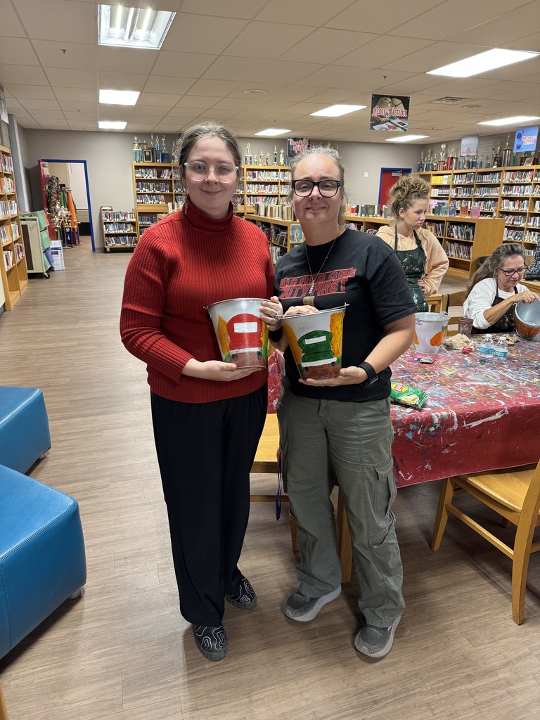 Families painting in a family paint night hosted by Partners for Rural Impact.