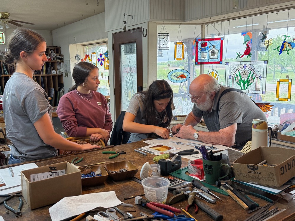 Students learning how to place glass in frames