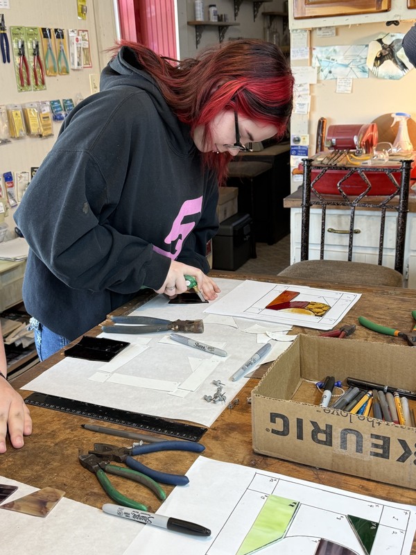 R. Schade learning to make stained glass art