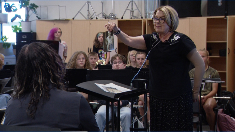 Janice Sharn Holds a Photo of her Late Father