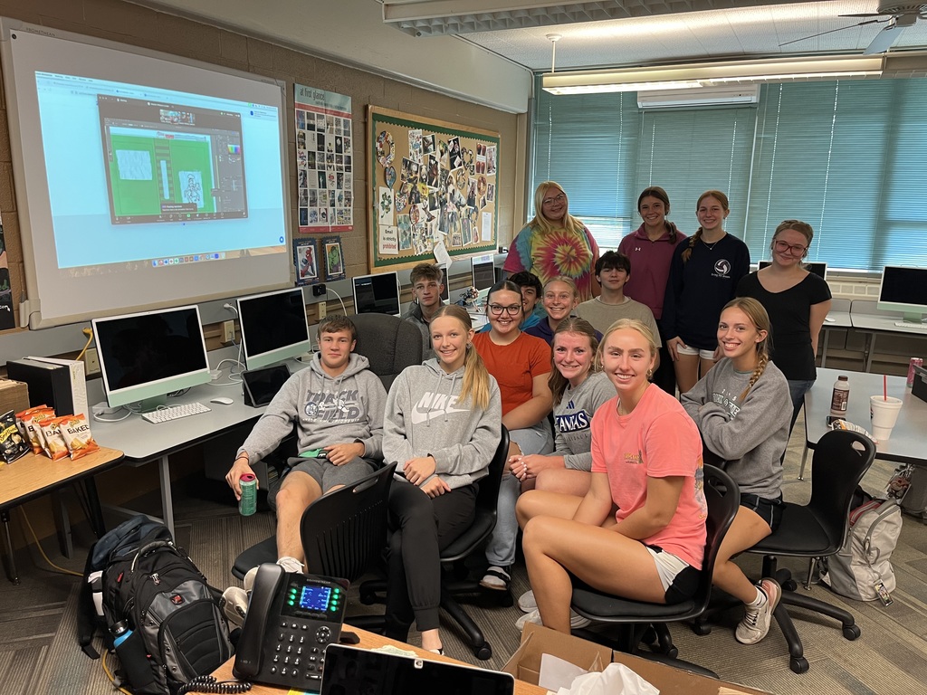 Yearbook students meeting with graphic designer
