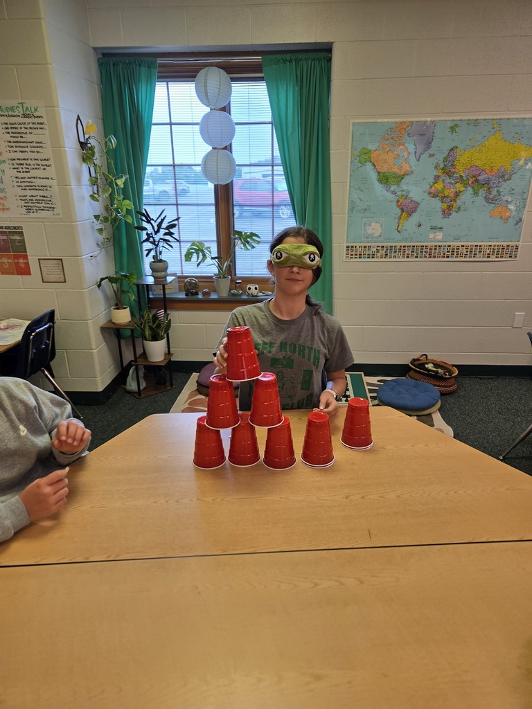 Blindfolded or using tiny hands to stack cups.