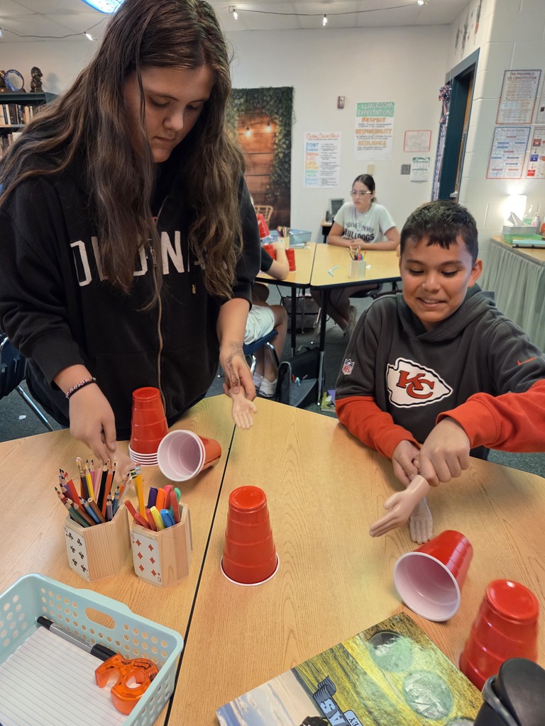 Blindfolded or using tiny hands to stack cups.