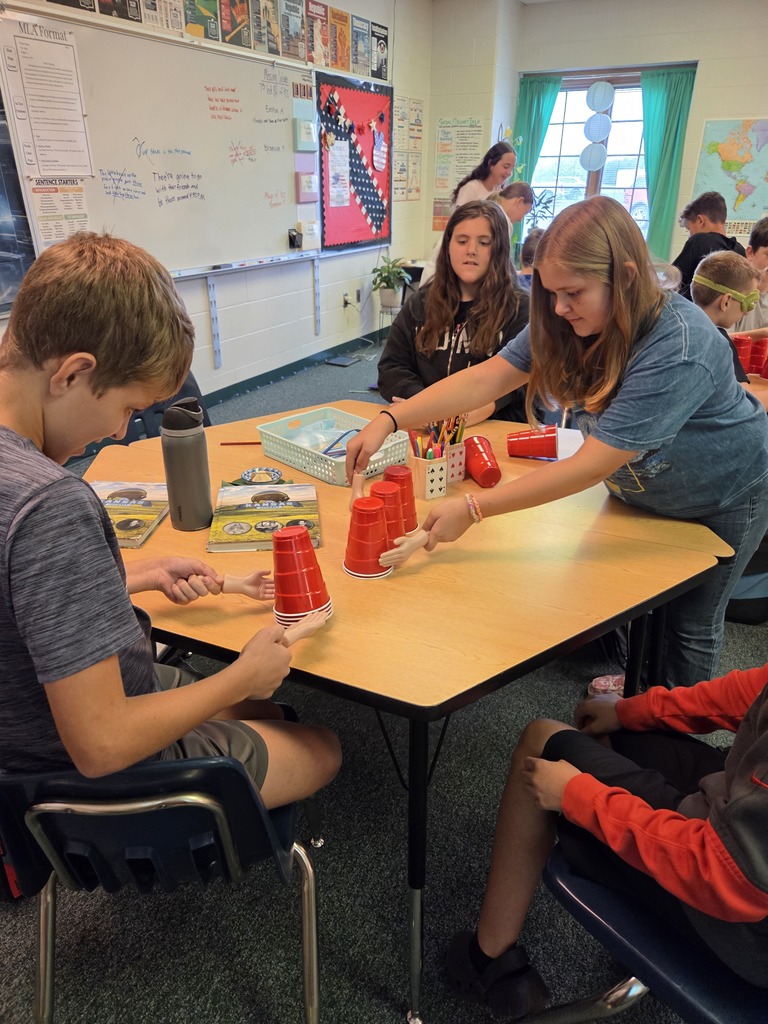 Blindfolded or using tiny hands to stack cups.