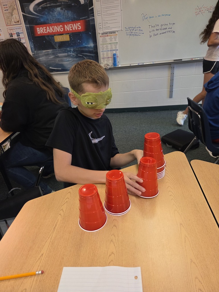 Blindfolded or using tiny hands to stack cups.