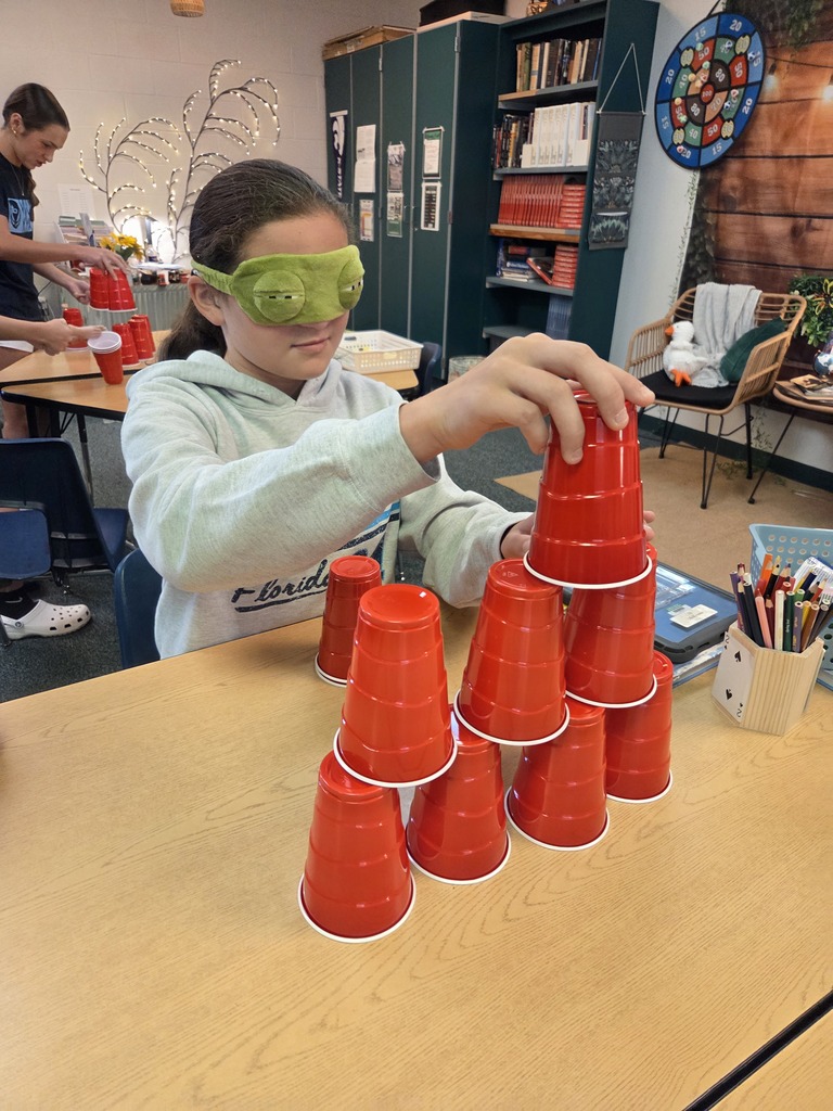 Blindfolded or using tiny hands to stack cups.