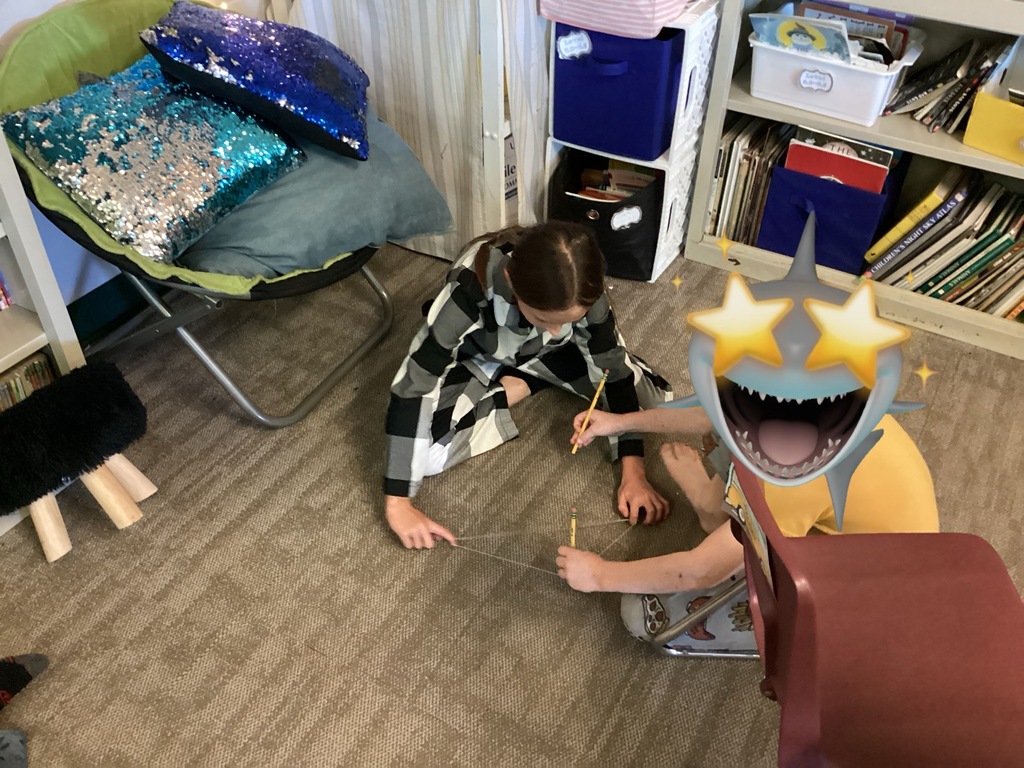 Two students performing an experiment with.