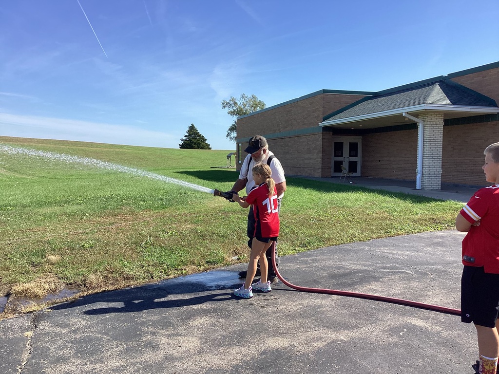 Student sprays firehose.