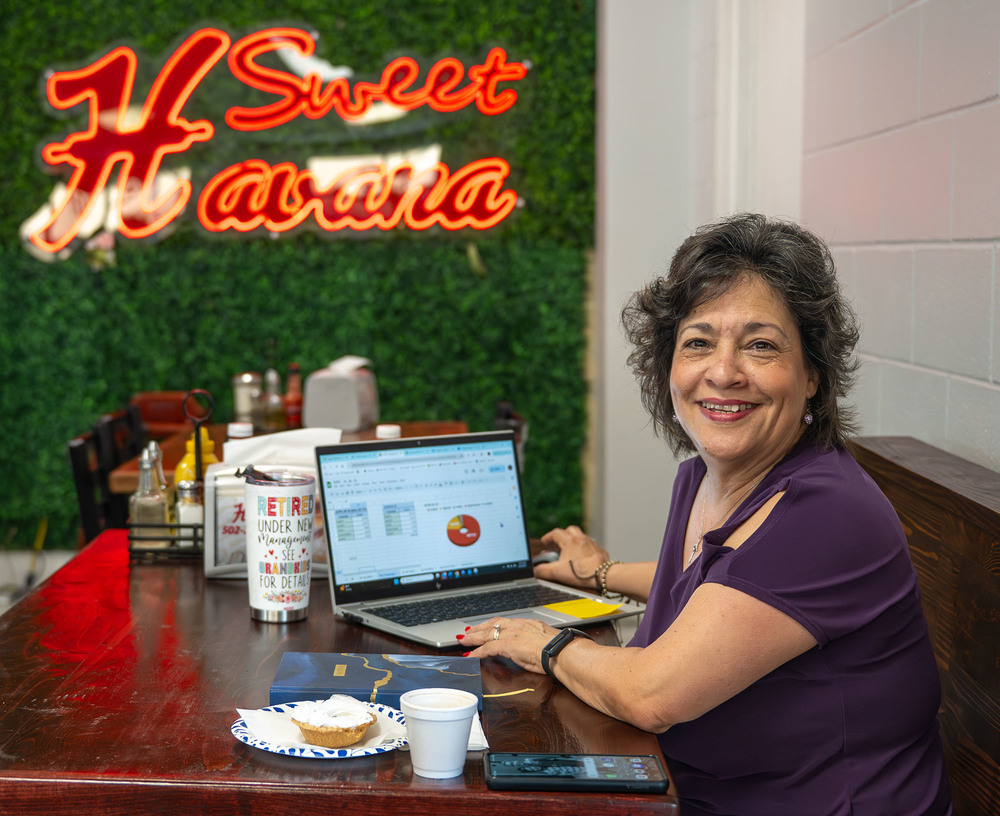 Berta Weyenberg sitting at a restaurant table smiling.