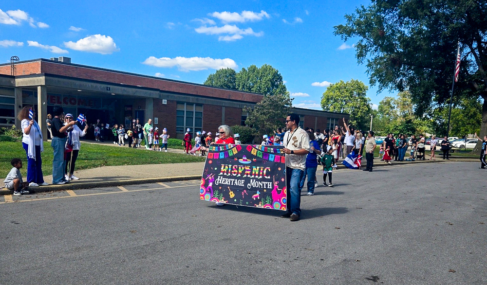 An elementary school celebrates Hispanic Heritage Month with a parade outside.