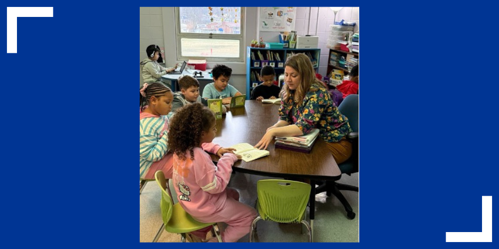 Ashley Roller teaches a group of students at a desk. 