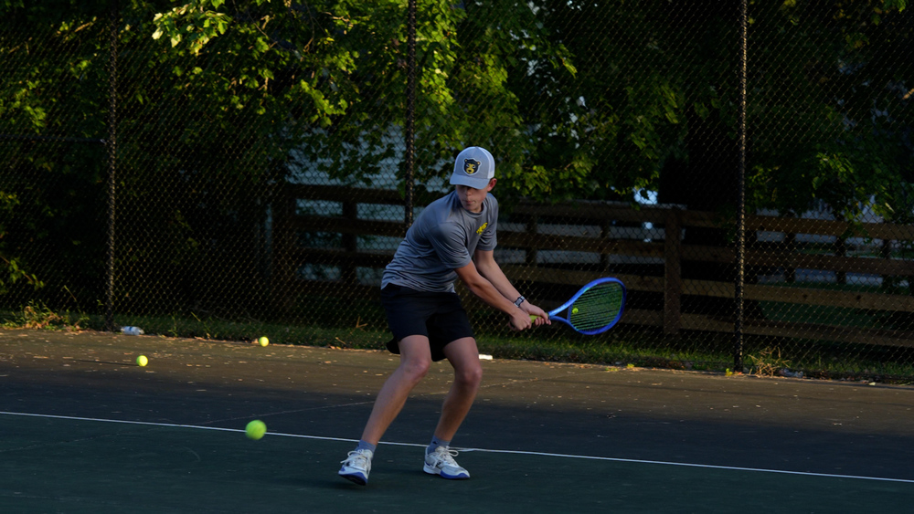 Boy about to hit a tennis ball