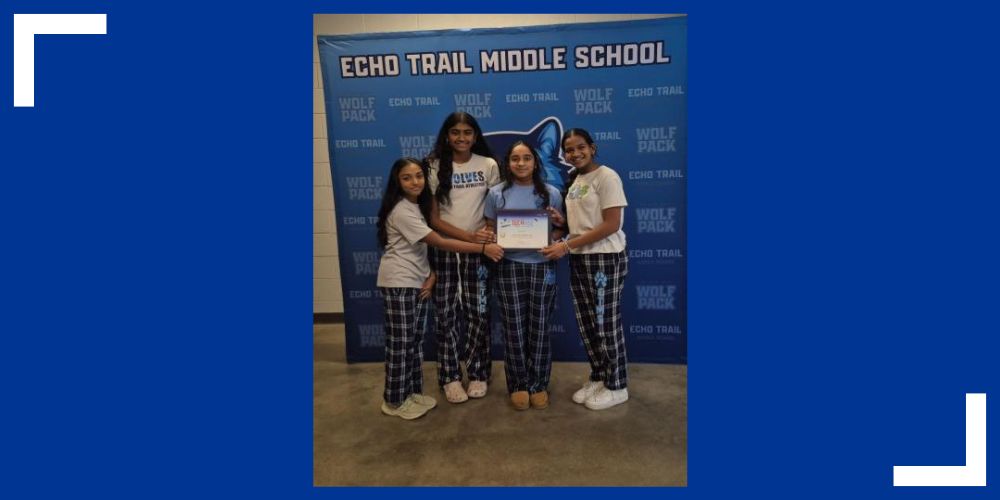 Four Echo Trail students pose for a picture and smile.