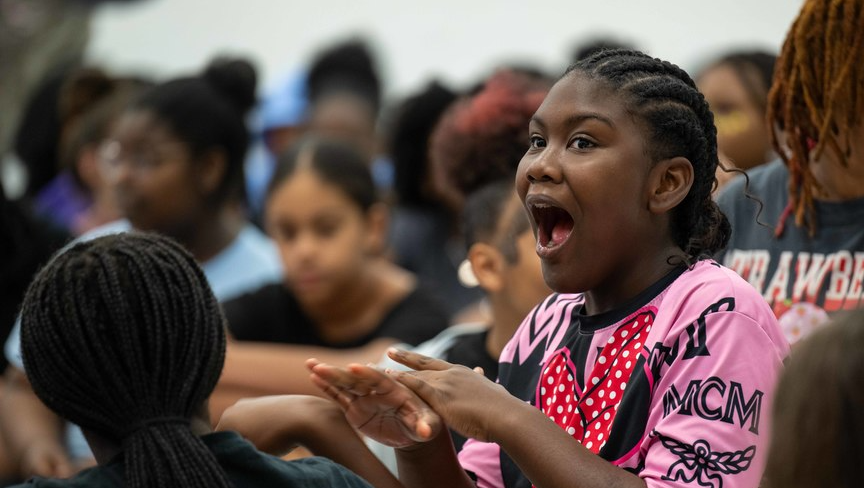 Student in a crowd, looking surprised.