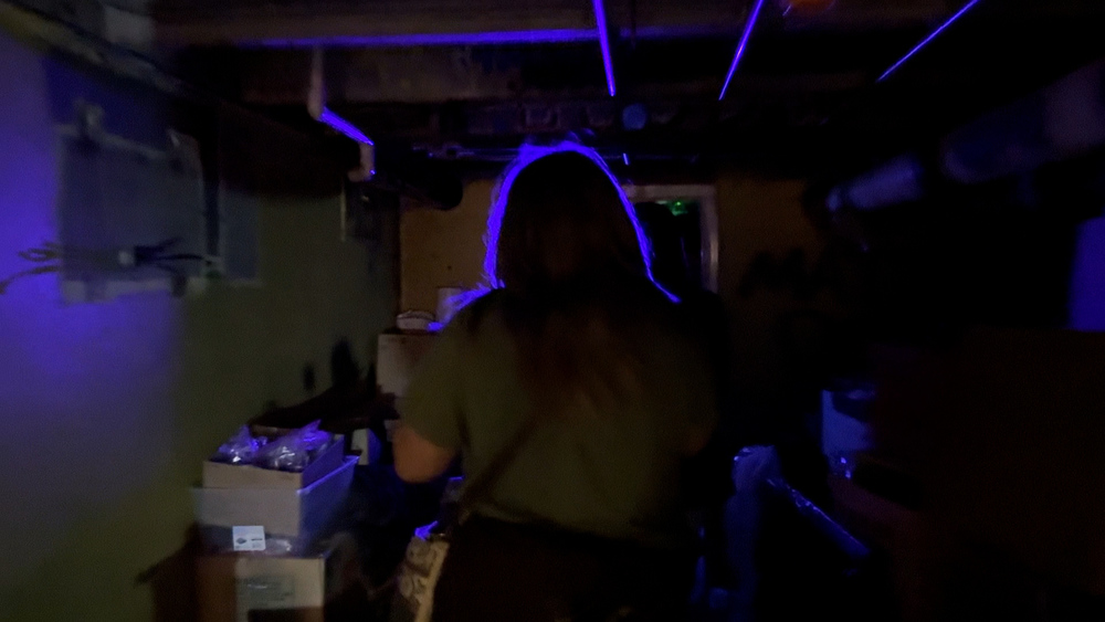 Student walking into a dark room