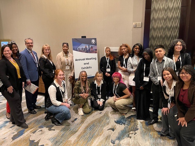 Students and adults pose for a picture.