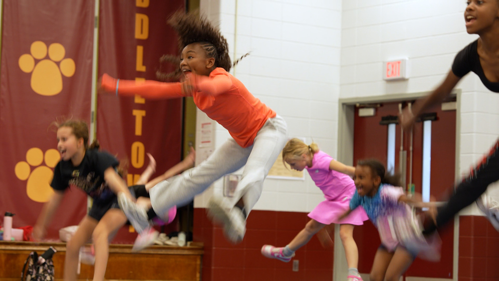 Girls jumping and smiling
