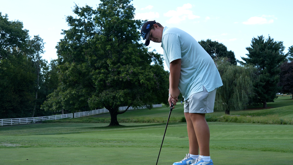 Eastern freshman Cade Wilson about to putt