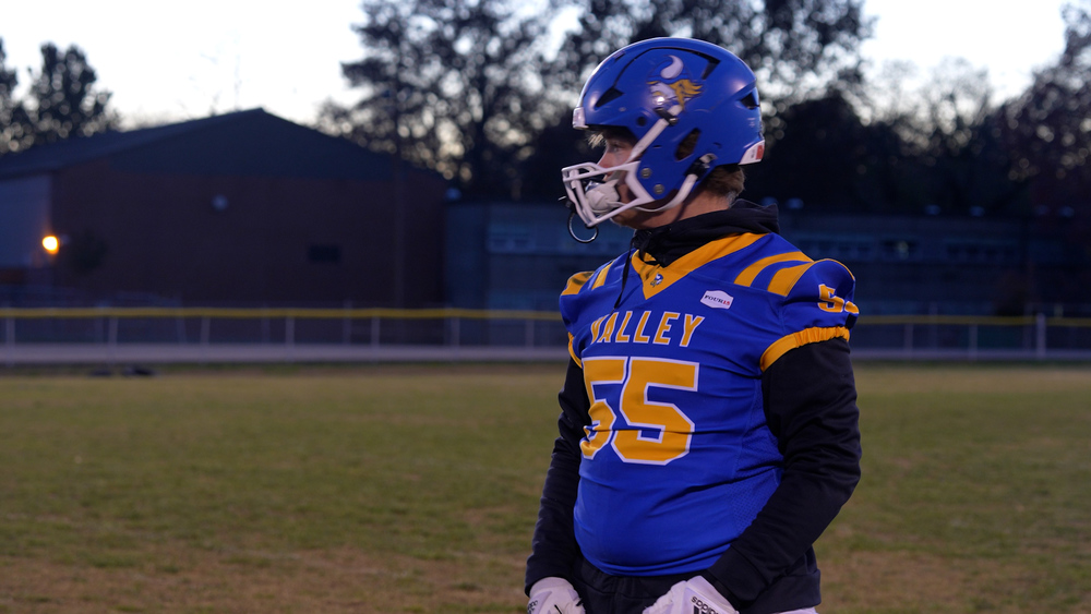 A football player wearing a jersey saying "Valley" across the chest, wearing number 55