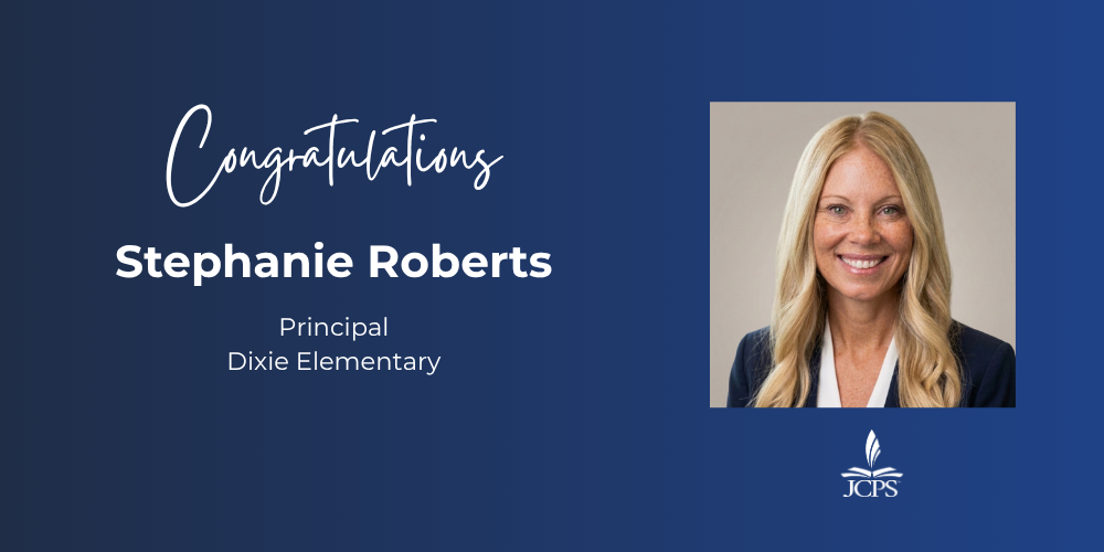 A graphic on a dark blue background that reads "Congratulations Stephanie Roberts, Principal, Dixie Elementary." To the right is a square headshot of Stephanie Roberts, a smiling woman with long blonde hair, wearing a dark blazer over a white top. The white JCPS logo is located in the bottom right corner.
