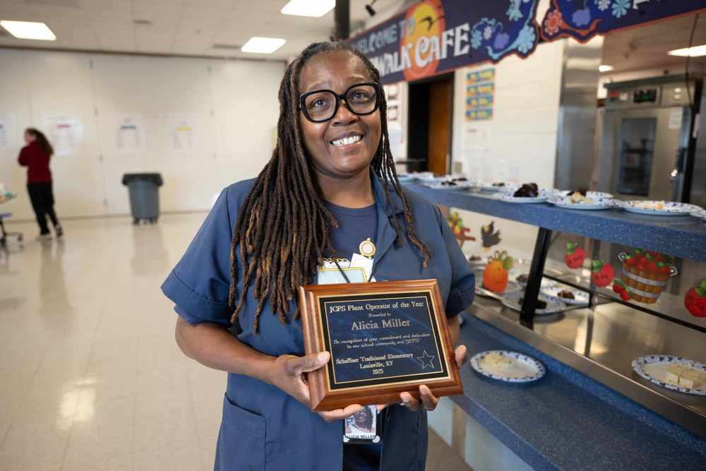 Plant Operator Alicia Miller smiles while holding new award 