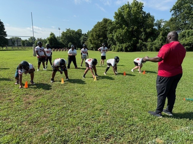 Football players in "down" position on practice field