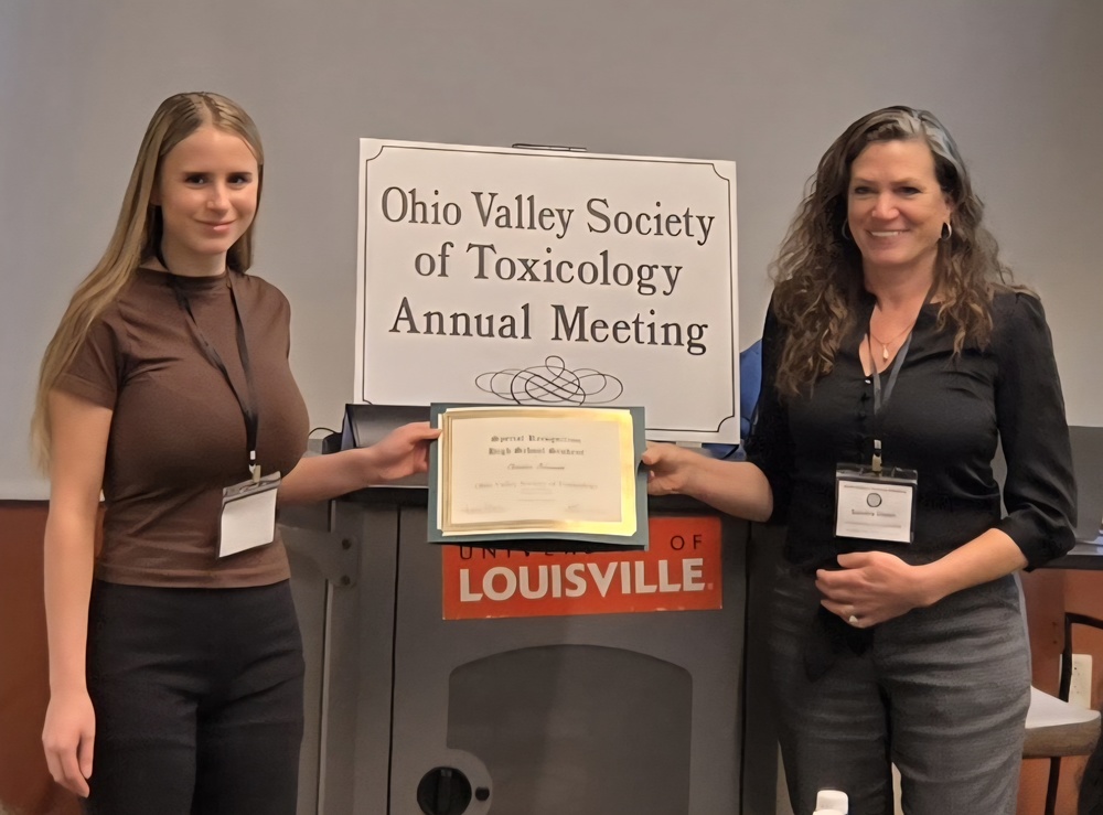 Two ladies holding a certificate