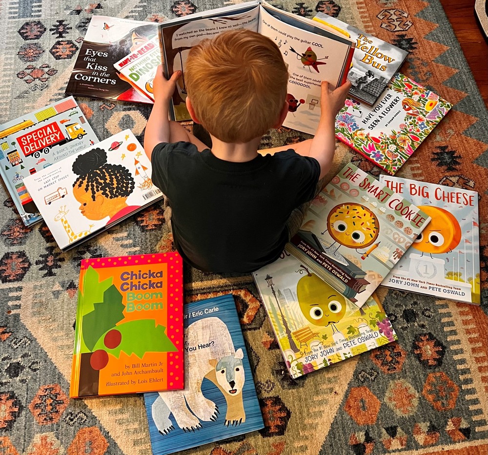 Child sitting on floor reading book