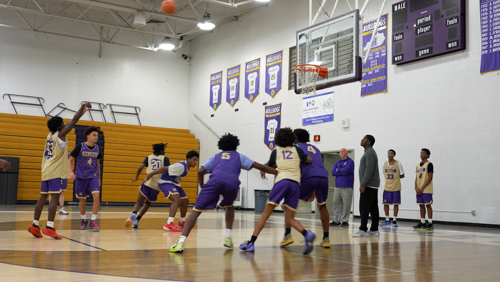 A basketball team on a court with someone shooting a free throw
