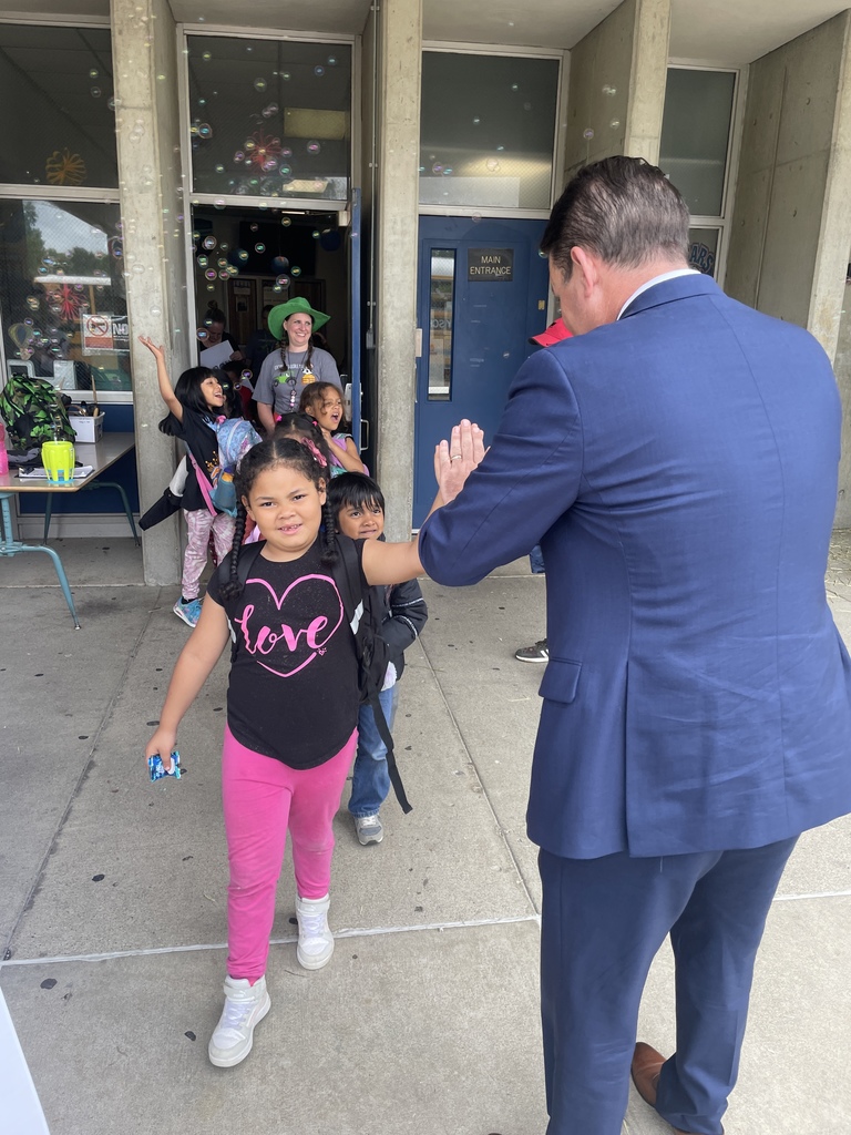 Students high fiving our Superintendent!