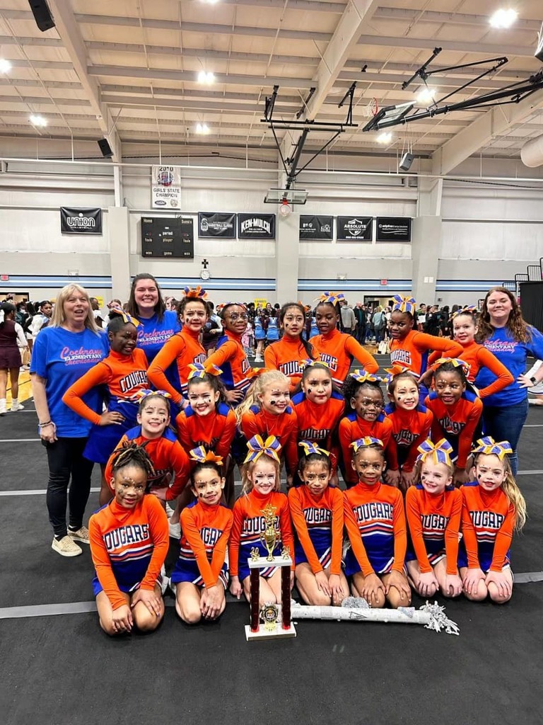 Cochrane cheerleading team with their trophy.