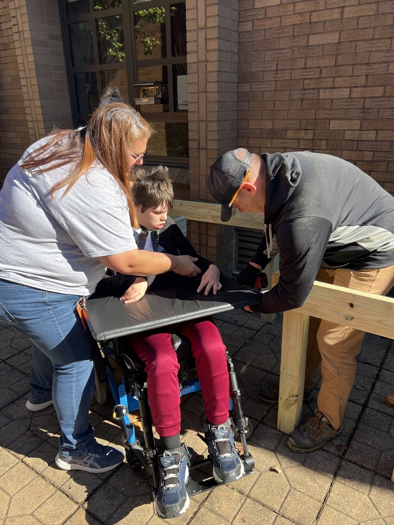 Student helping build planters.