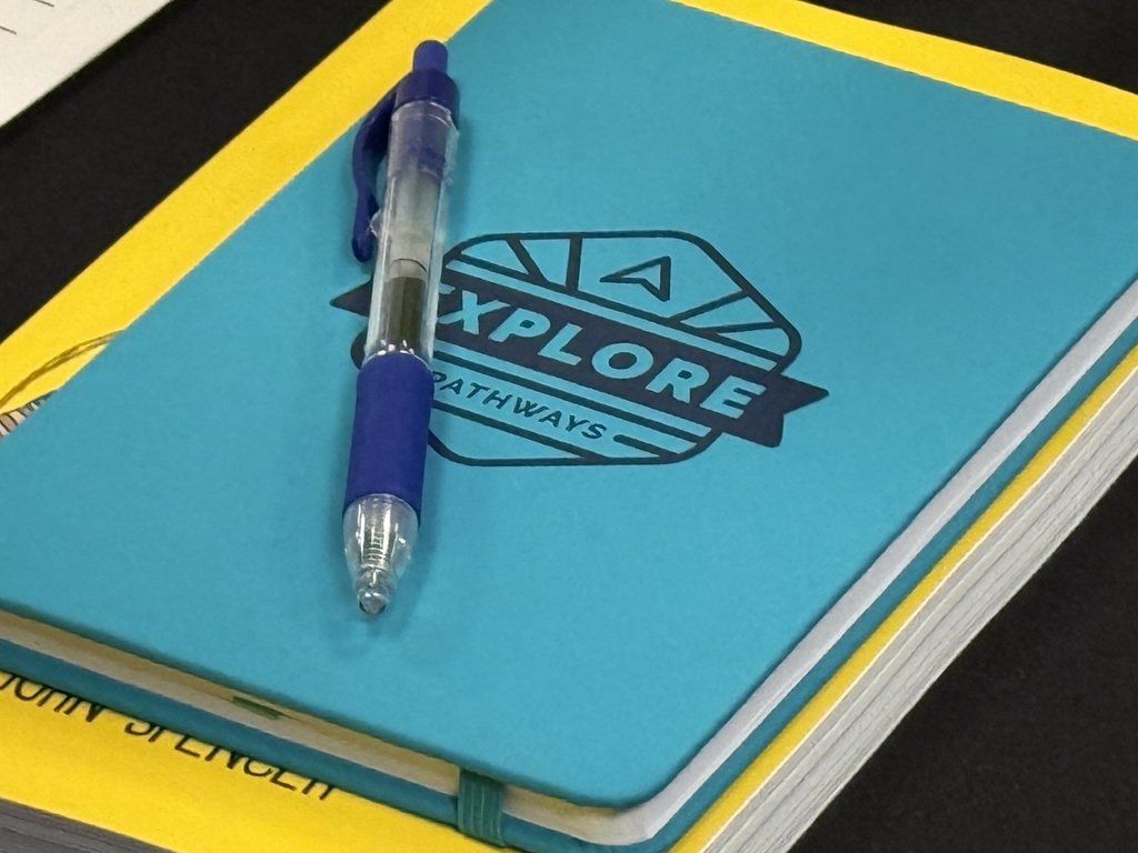 An Explore Pathways notebook sits on a table.