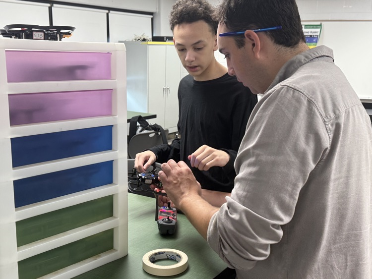 Photo of students and their drone
